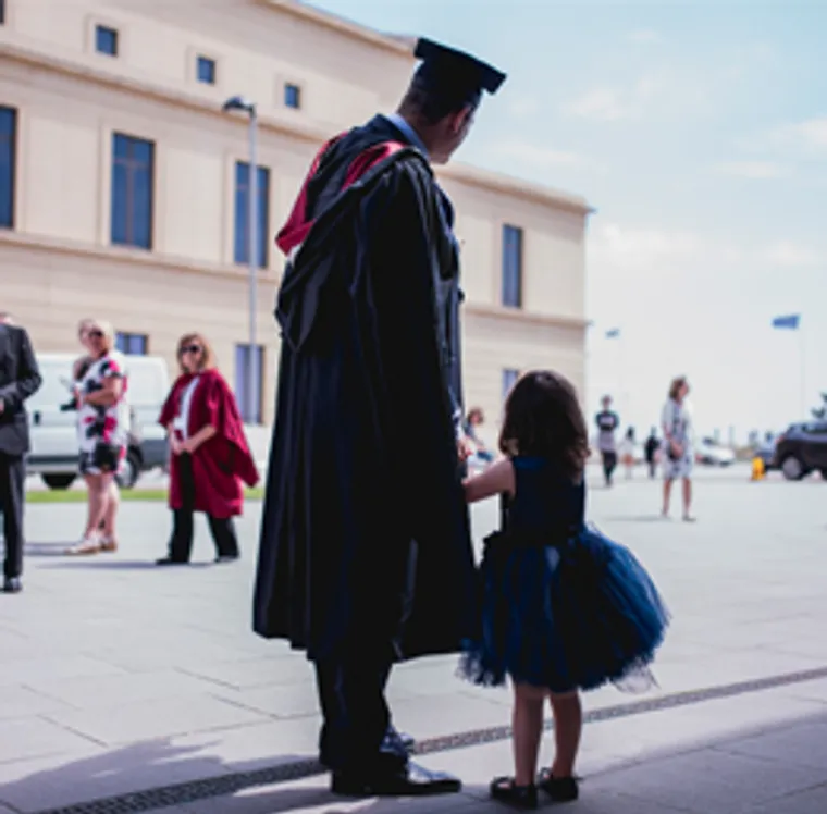 Man and child at graduation